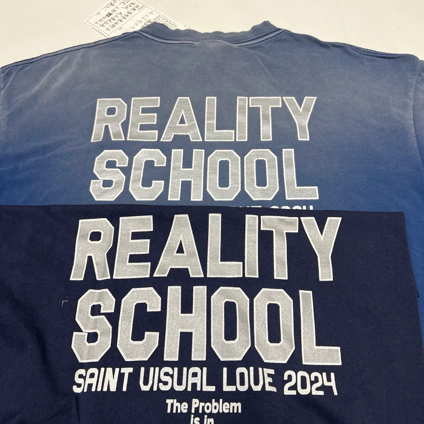 Printing proofing SAINT Mxxxxxx REALITY SCHOOL SS_TEE/NVY Slogan distressed short-sleeves Washed blue S-XL Garment dyeing Ma Liu fading Super complex shearing and destruction treatment Correct version Cylindrical fabric Customized original consistent main mark/wash mark Original consistent silver powder printing Distressed treatment